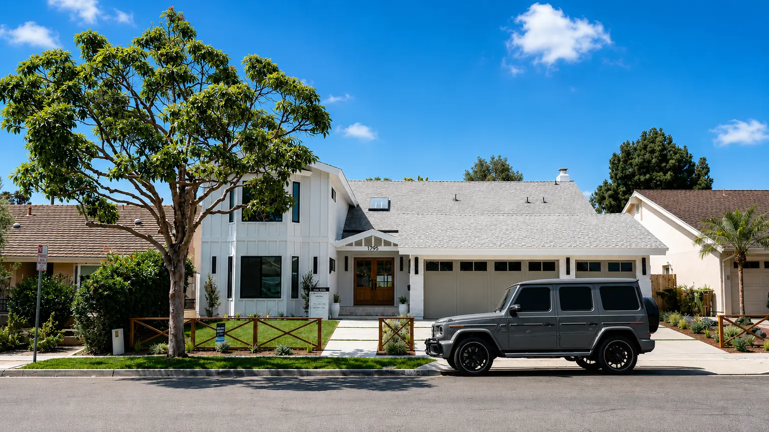 Modern white two-story home with wood front doors and a landscaped front yard in Orange County